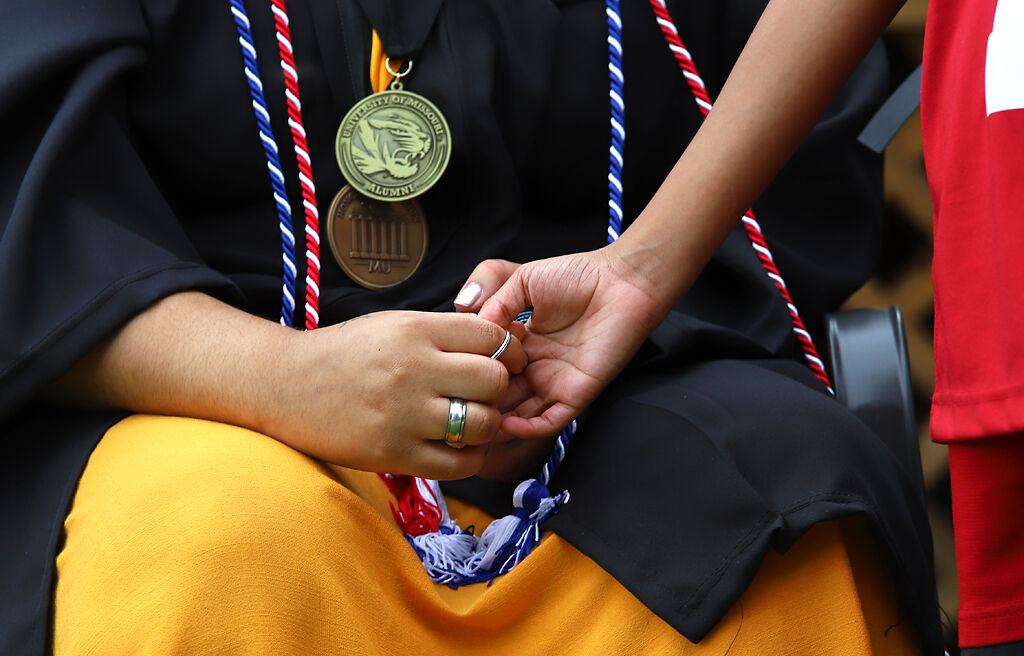 Jasmine-Kay Johnson’s brother takes her hand on Saturday, August 1, 2020, in Alton, Illinois